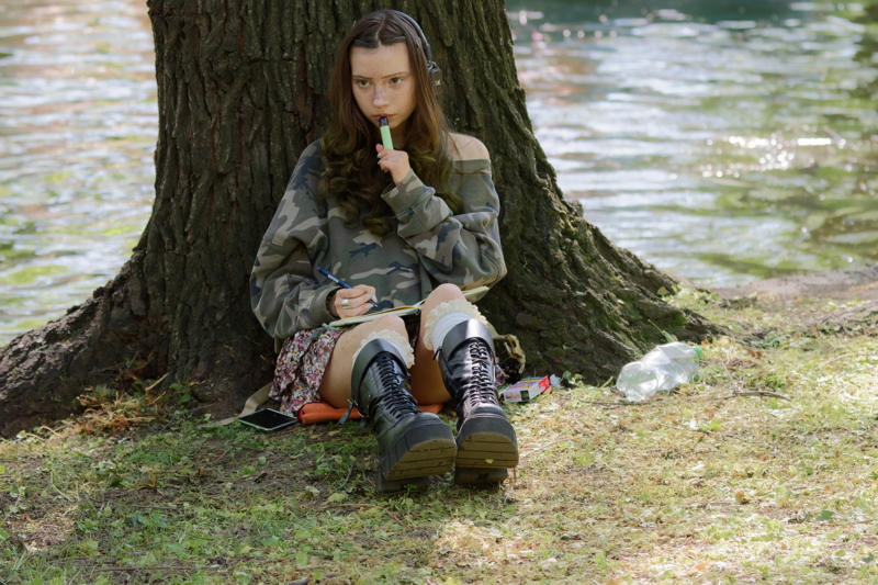 Girl leaning against a tree trunk 1